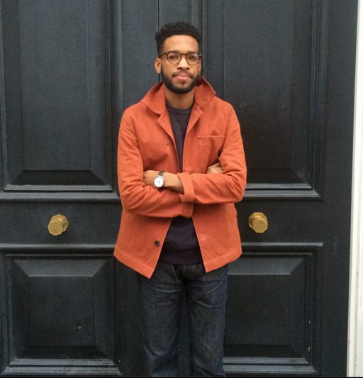 A man wearing an orange Albam overshirt with dark washed jeans