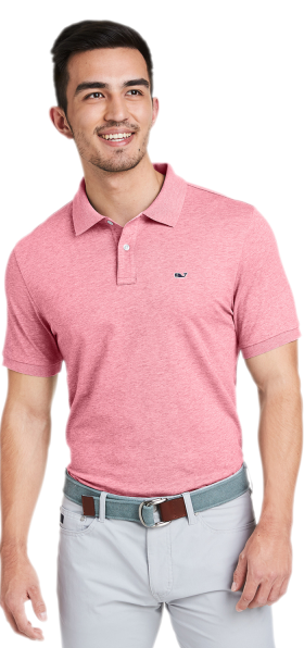 A man wearing a pink Vineyard Vines collared shirt with grey slacks