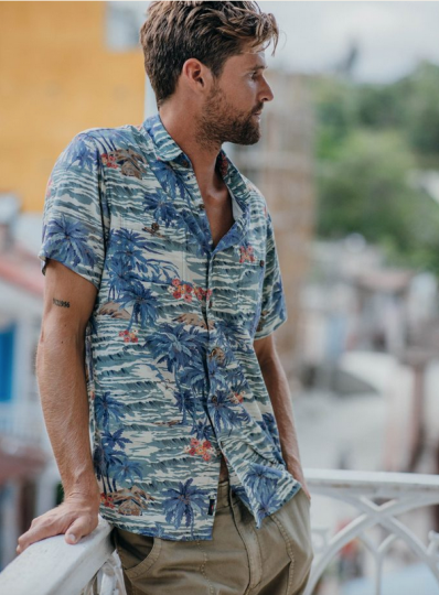 A man wearing a blue Hawaiian button up from Faherty