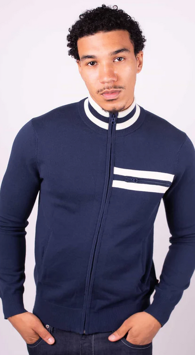 A man wearing a tight fitted navy blue zip up by Merc