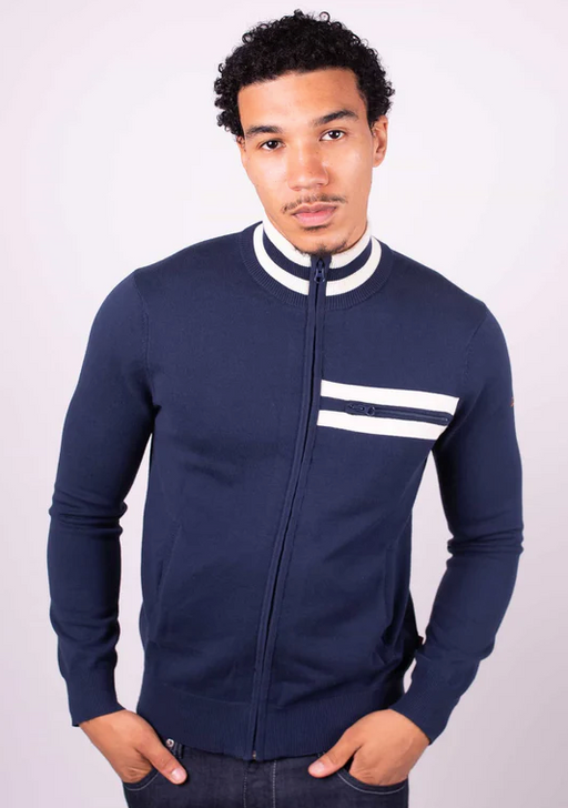 A man wearing a tight fitted navy blue zip up by Merc