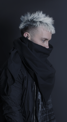 A man wearing a oversize AOKU black scarf and jacket