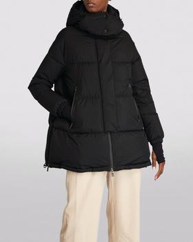 A man wearing a HERNO LAMINAR black long puffy jacket with beige pants