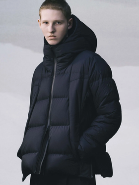 A man wearing a black DESCENTE ALLTERRAIN puffy jacket