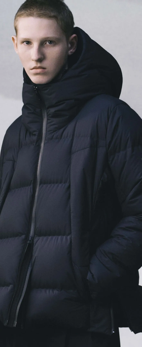 A man wearing a black DESCENTE ALLTERRAIN puffy jacket