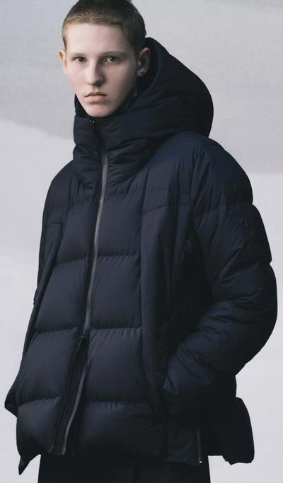 A man wearing a black DESCENTE ALLTERRAIN puffy jacket