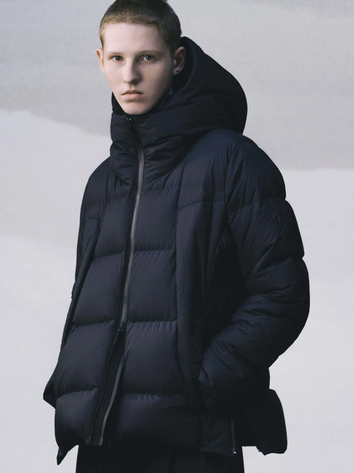 A man wearing a black DESCENTE ALLTERRAIN puffy jacket