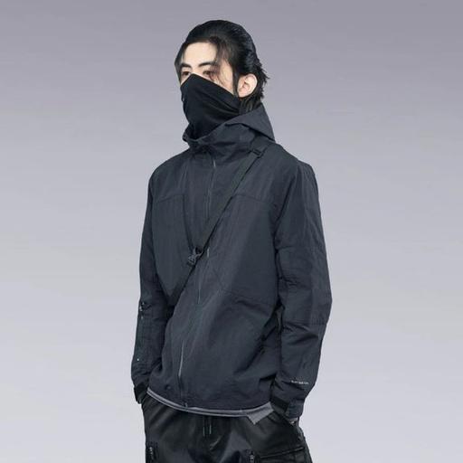 A man wearing a clotechnow black outfit featuring a black mask and technical jacket
