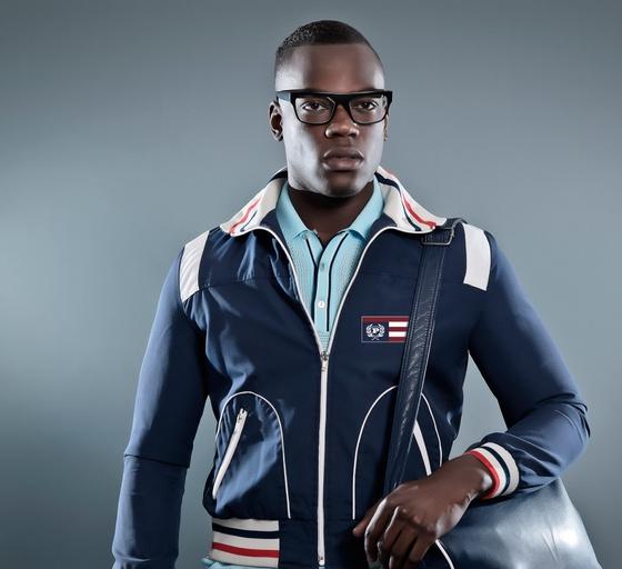 A man wearing a PHAT FARM zip up and a modern blue button up