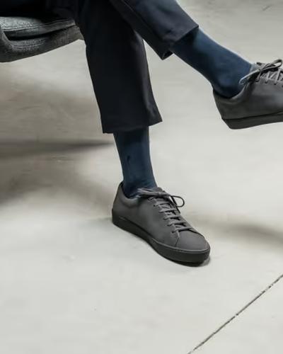 A man wearing JAK minimalist dark grey shoes
