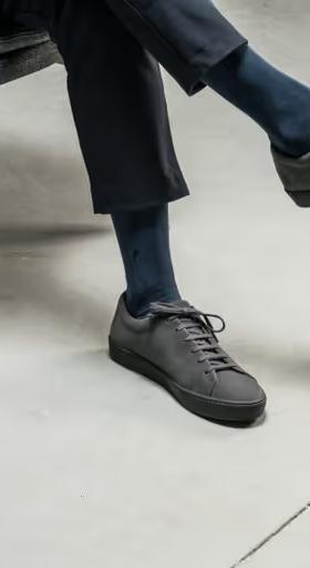 A man wearing JAK minimalist dark grey shoes