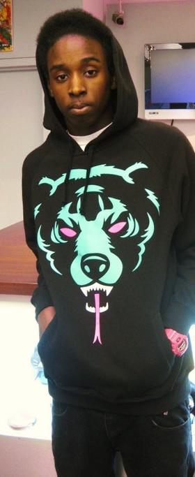 A man wearing a classic light blue and pink Mishka bear hoodie