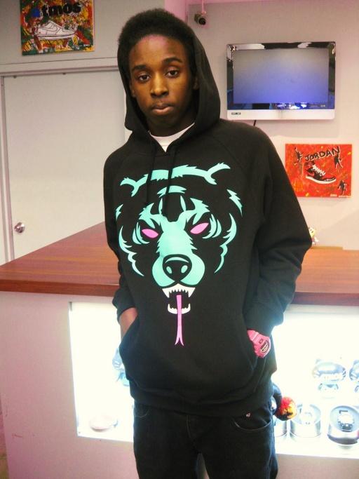 A man wearing a classic light blue and pink Mishka bear hoodie