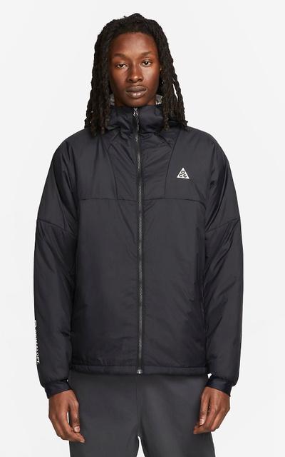 A man wearing a Nike ACG black jacket
