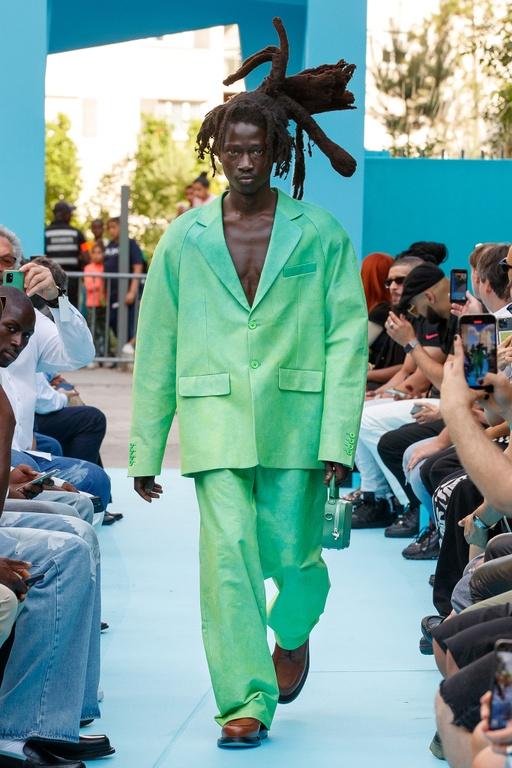 A man walking the runway in a green oversize suit by 3.Paradis