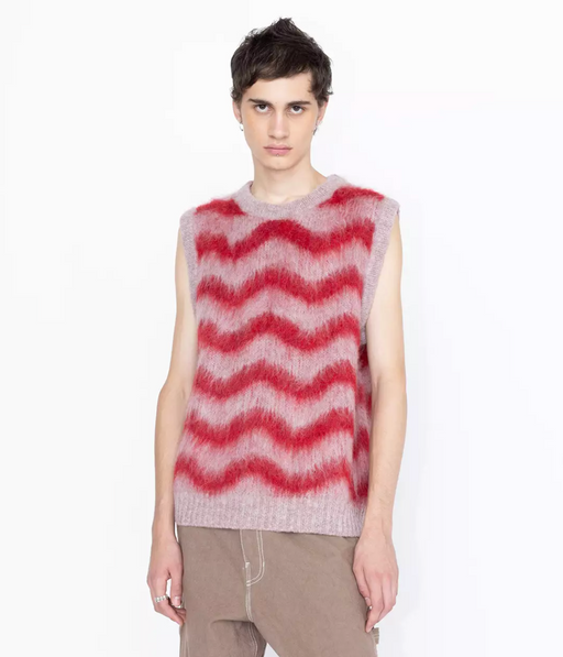 A man wearing a Highsnobiety striped pink and red vest in alpaca