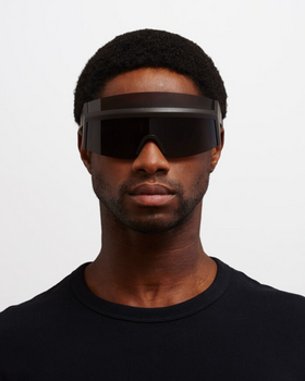 A man wearing oversize Mykita 'fast' sunglasses in all-black