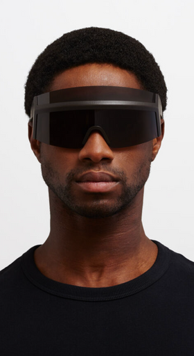 A man wearing oversize Mykita 'fast' sunglasses in all-black