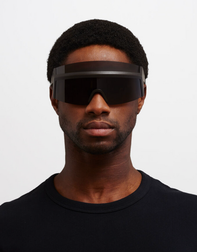 A man wearing oversize Mykita 'fast' sunglasses in all-black