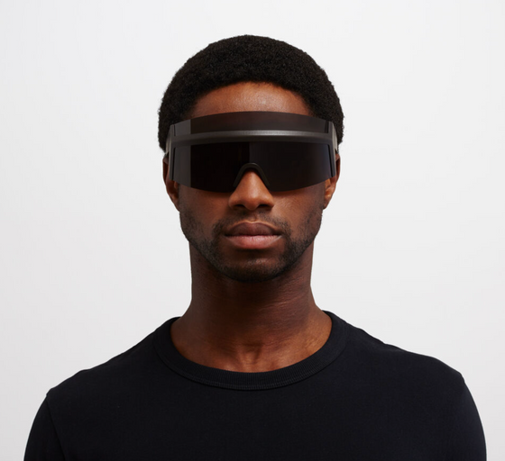 A man wearing oversize Mykita 'fast' sunglasses in all-black