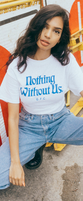 A woman wearing a 'nothing without us' Get Fresh Company t-shirt and blue jeans