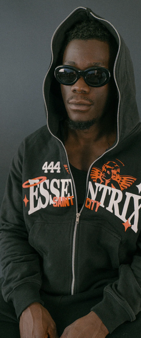 A man wearing an Essentrix branded zip up hoodie with sunglasses
