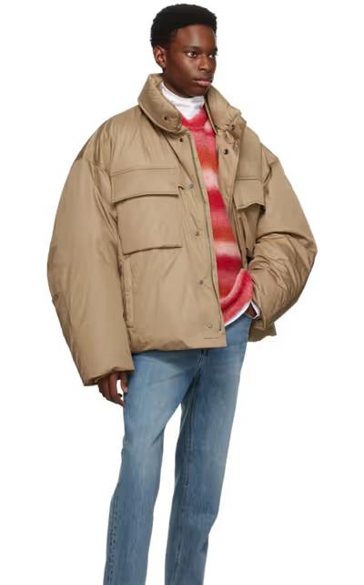 A man wearing an oversize WOOYOUNGMI brown jacket with jeans