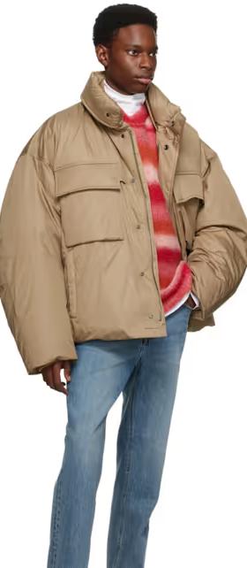 A man wearing an oversize WOOYOUNGMI brown jacket with jeans