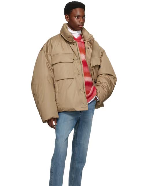 A man wearing an oversize WOOYOUNGMI brown jacket with jeans