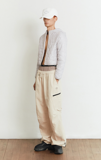A man wearing a beige off white MSCHF outfit