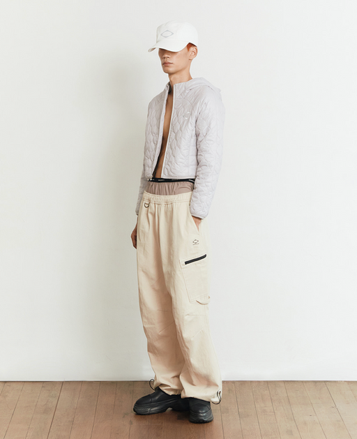A man wearing a beige off white MSCHF outfit
