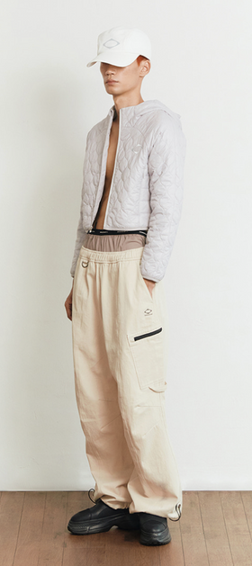 A man wearing a beige off white MSCHF outfit