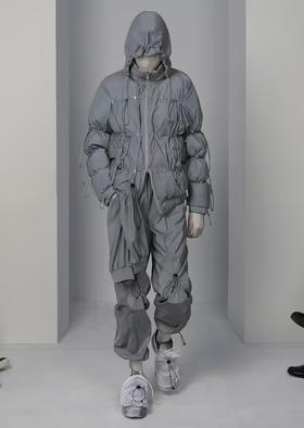 A man wearing a futuristic Post Archive Fashion technical outfit