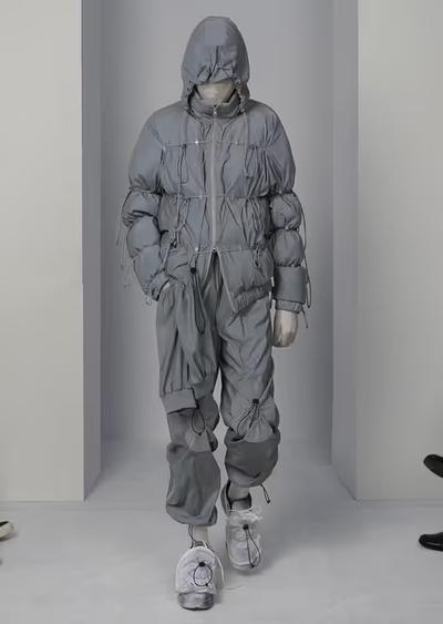 A man wearing a futuristic Post Archive Fashion technical outfit