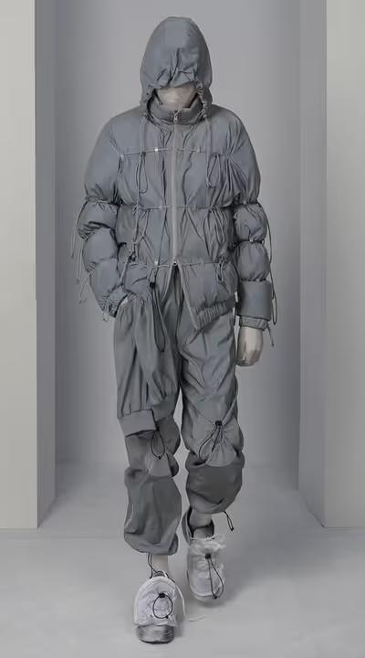 A man wearing a futuristic Post Archive Fashion technical outfit