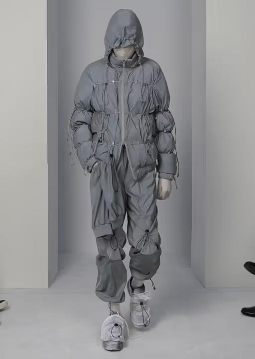 A man wearing a futuristic Post Archive Fashion technical outfit