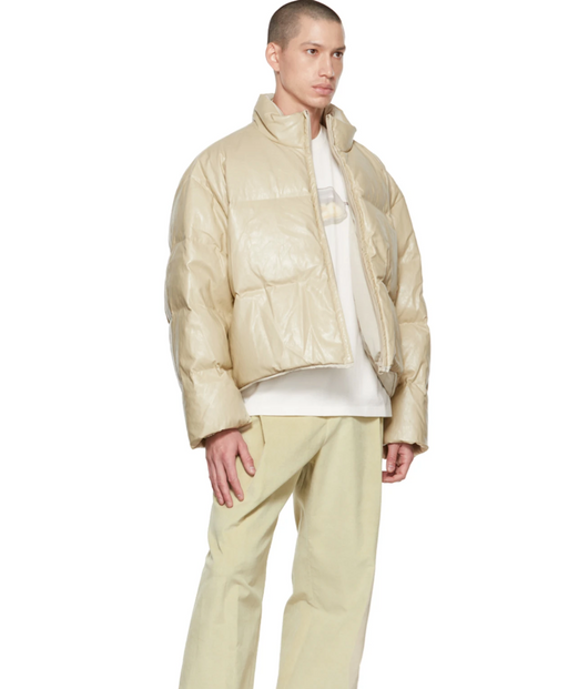 A man wearing an AMOMENTO light biege jacket and pants with a white t-shirt