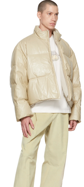 A man wearing an AMOMENTO light biege jacket and pants with a white t-shirt