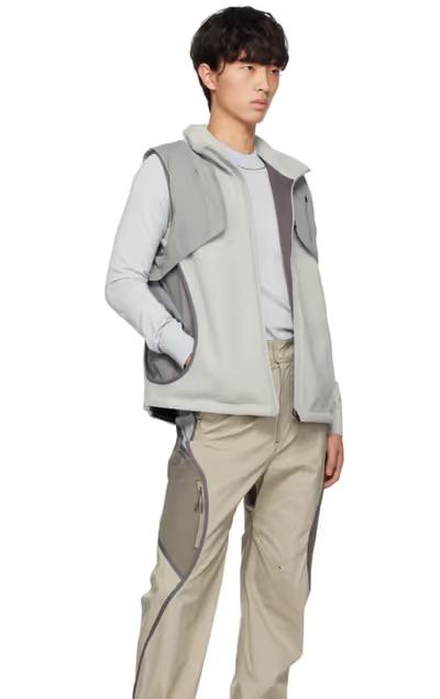 A man wearing a grey Hyein Seo vest and beige pants