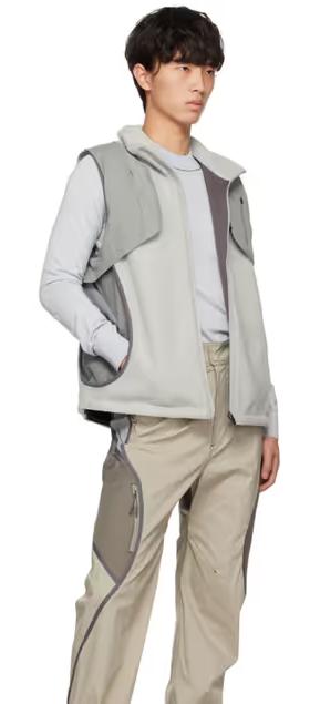 A man wearing a grey Hyein Seo vest and beige pants
