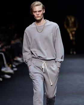 A man wearing a grey sweatsuit by Pushbutton