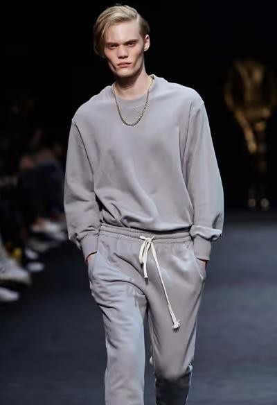 A man wearing a grey sweatsuit by Pushbutton