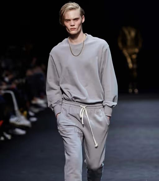 A man wearing a grey sweatsuit by Pushbutton