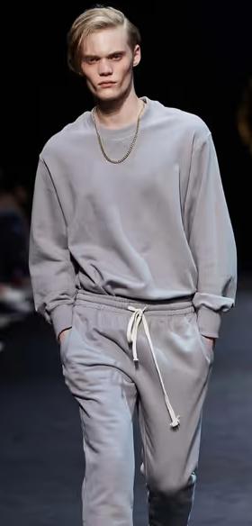 A man wearing a grey sweatsuit by Pushbutton