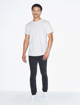 A man wearing a simple white t-shirt and tight black pants by American Apparel