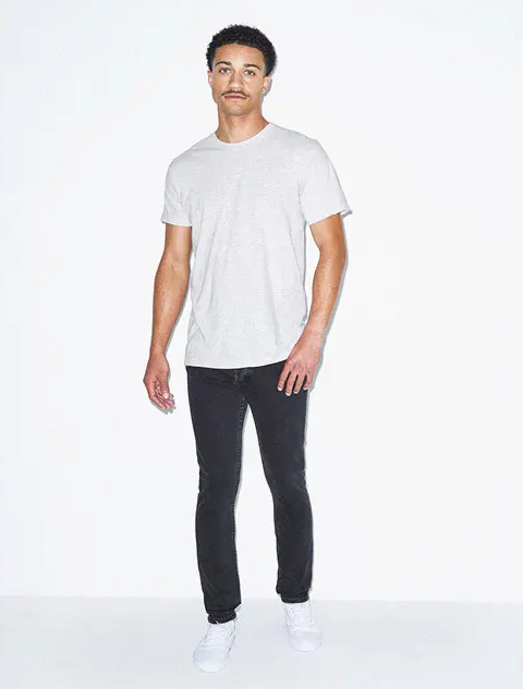 A man wearing a simple white t-shirt and tight black pants by American Apparel