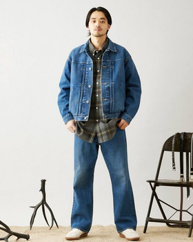 A man wearing a denim Journal Standard jacket with matching pants