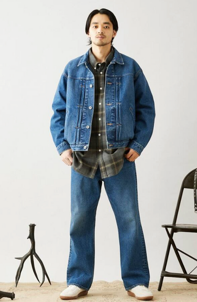 A man wearing a denim Journal Standard jacket with matching pants