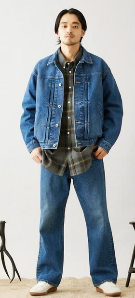 A man wearing a denim Journal Standard jacket with matching pants