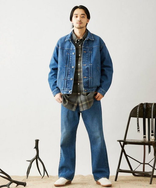 A man wearing a denim Journal Standard jacket with matching pants